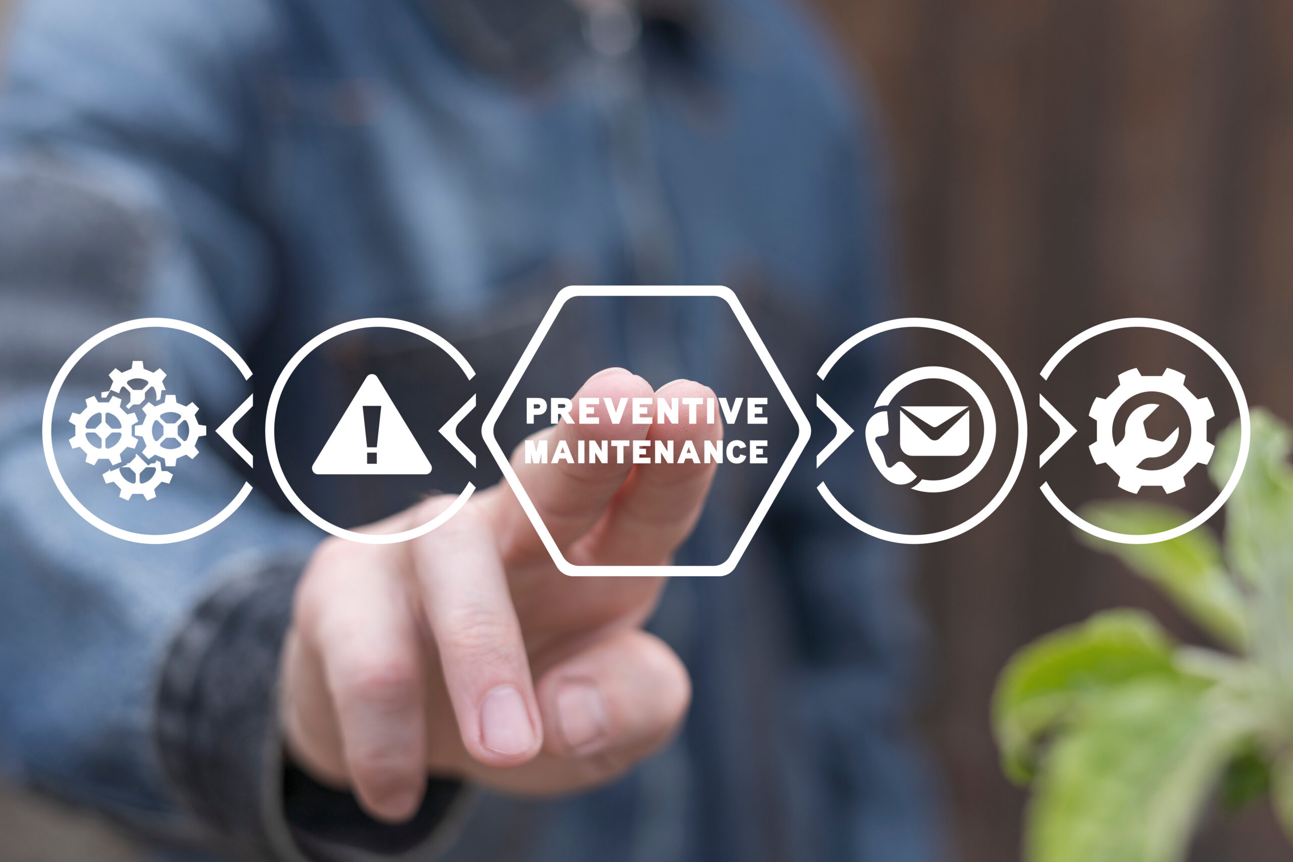 man working on virtual touch screen of future presses inscription: preventive maintenance. preventive maintenance business industry concept.