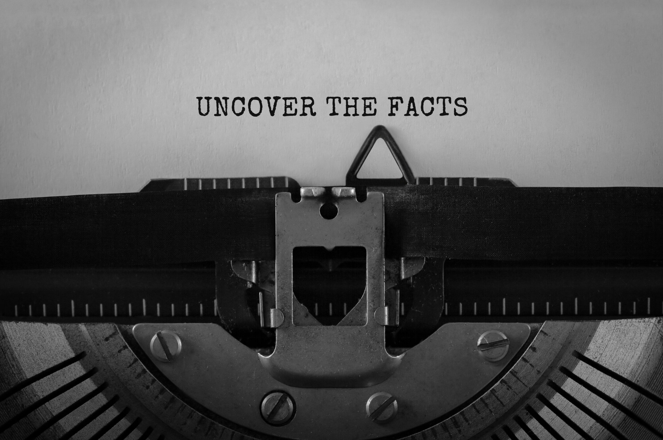 text uncover the facts typed on retro typewriter